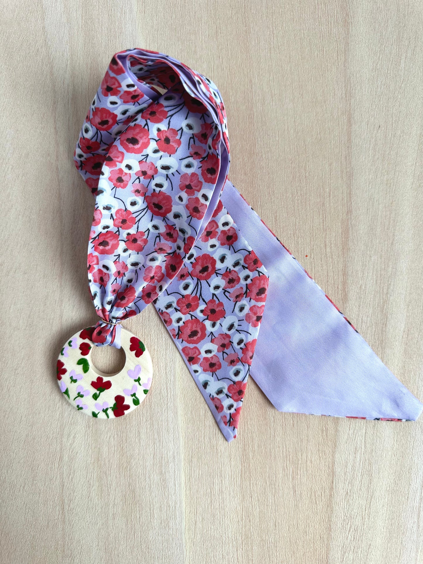 Adorno para bolso flores rojas y fondo lila (con agujero).